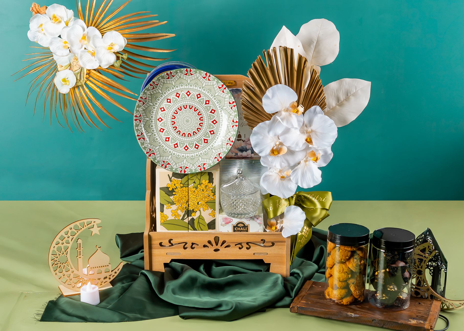 Purnama hamper on a carved wooden tray with orchids, dates and homemade cookies